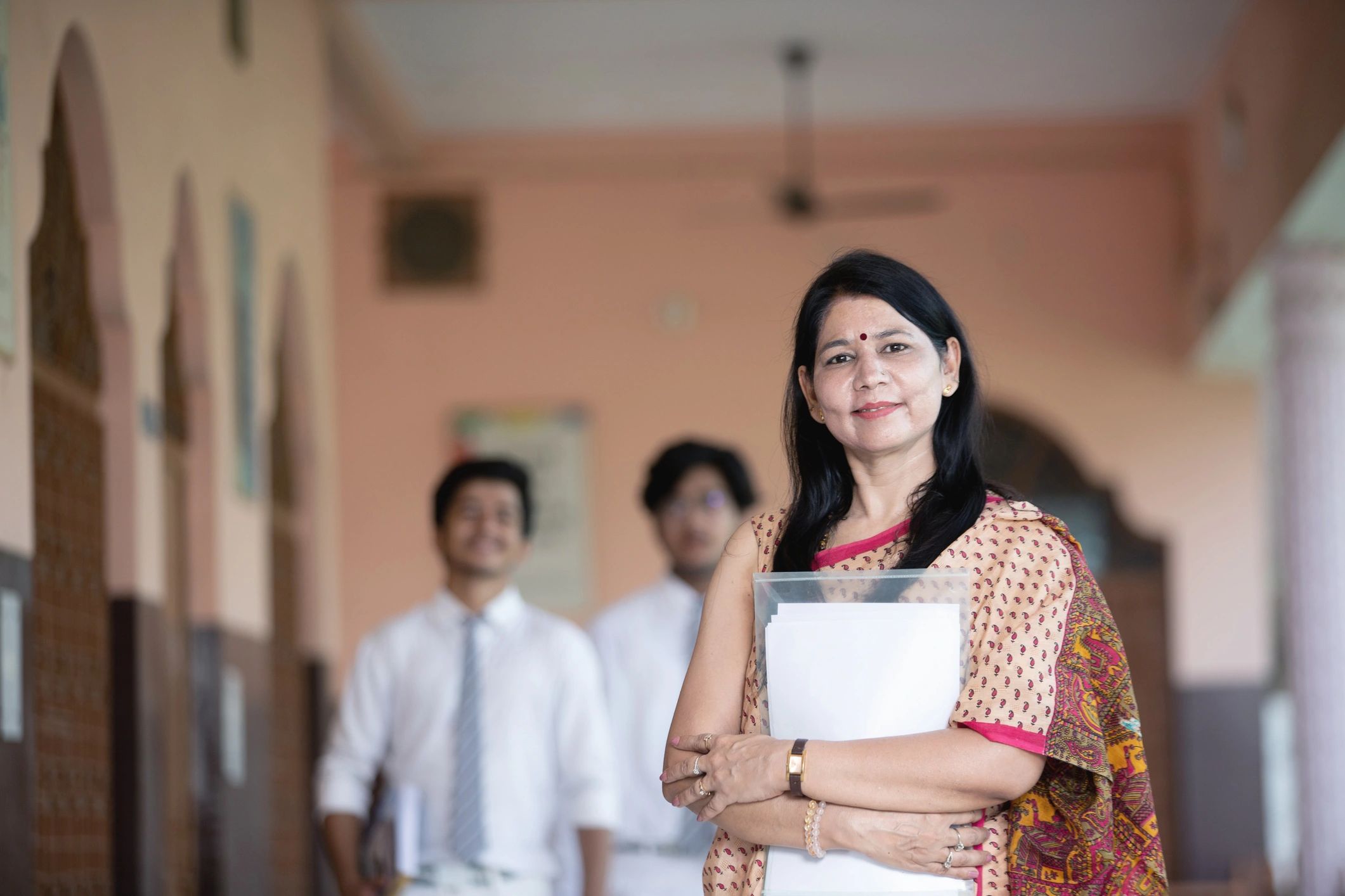 Confident Indian teacher with students